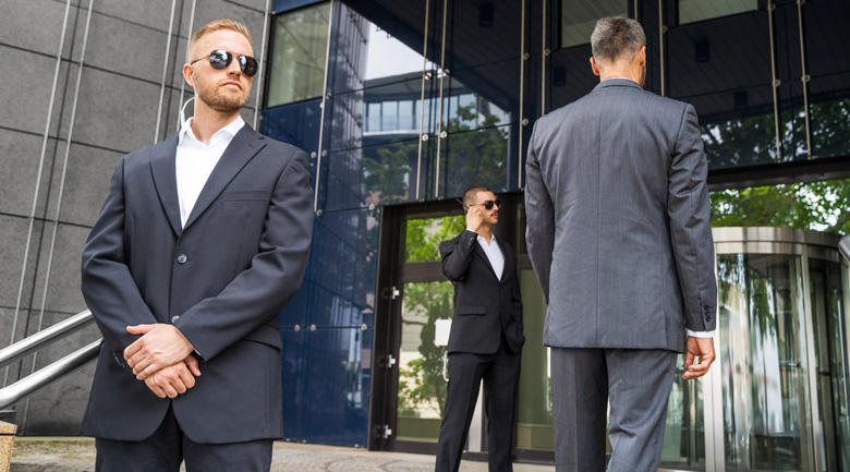 Armed security officers outside building